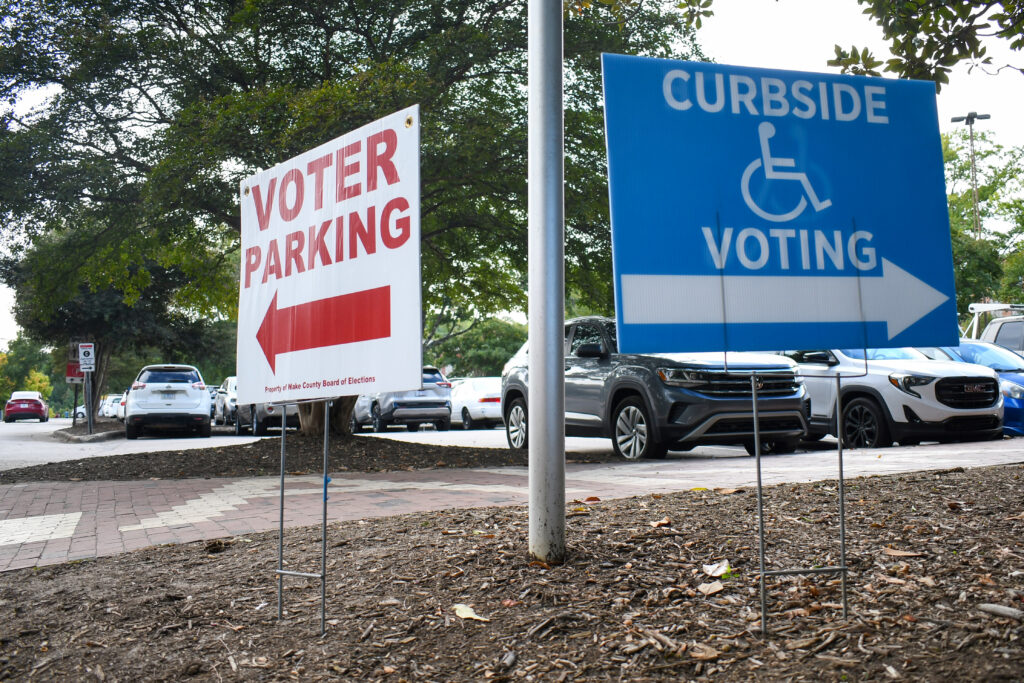 Two signs with directions to voting entrances in front of Talley Student Center.