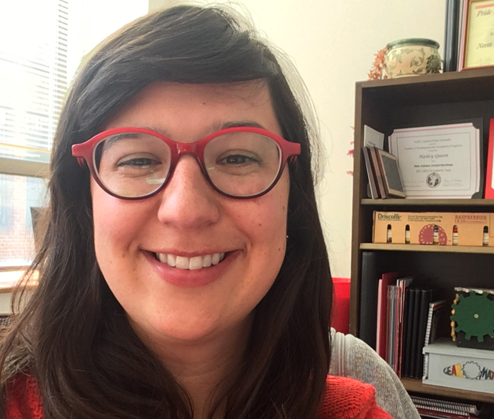 Photo of Haily Queen in her office wearing glasses.