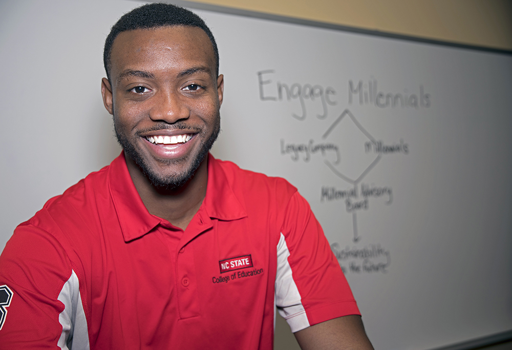 Marcus Howard standing in front of whiteboard that reads "Engage Millennials"