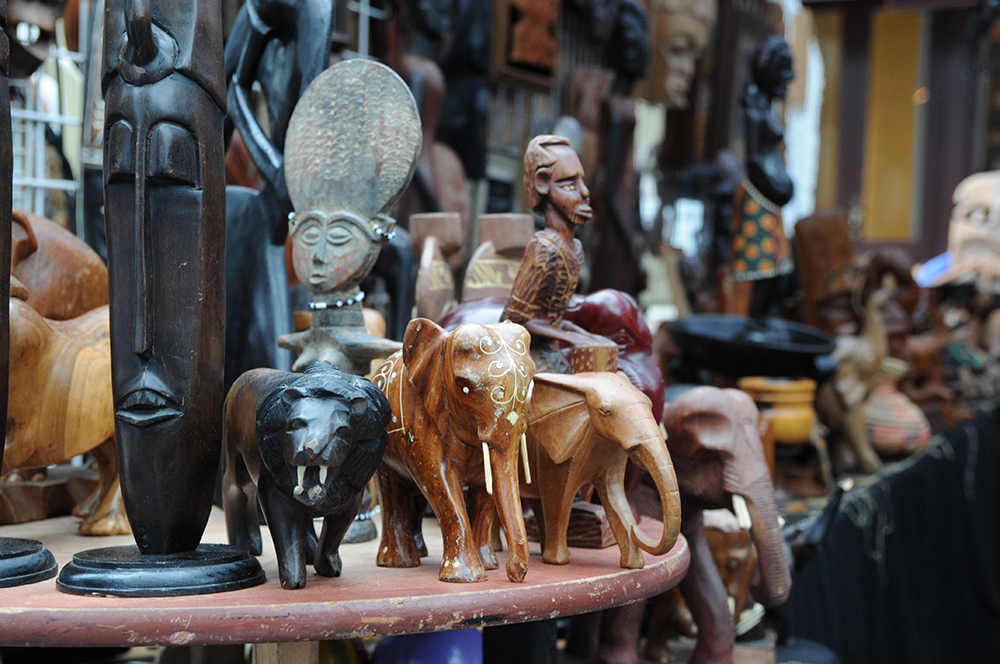 Traditional African wood carvings stand on display in front of a vendor tent at the African American Cultural Festival of Raleigh and Wake County.