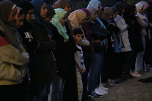 Students and community members join together in prayer at a vigil for the victims of the shooting in New Zealand.