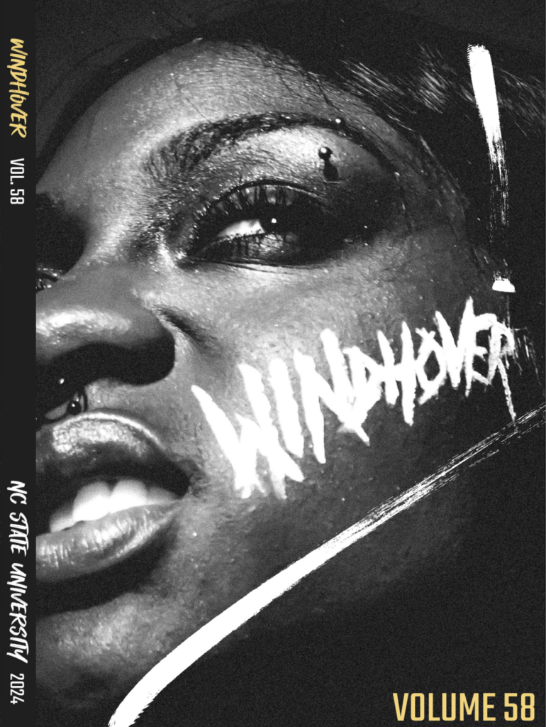 Volume 58 of Windhover. Cover shows a face in black and white looking to the left with the word "Windhover" painted on the cheek.